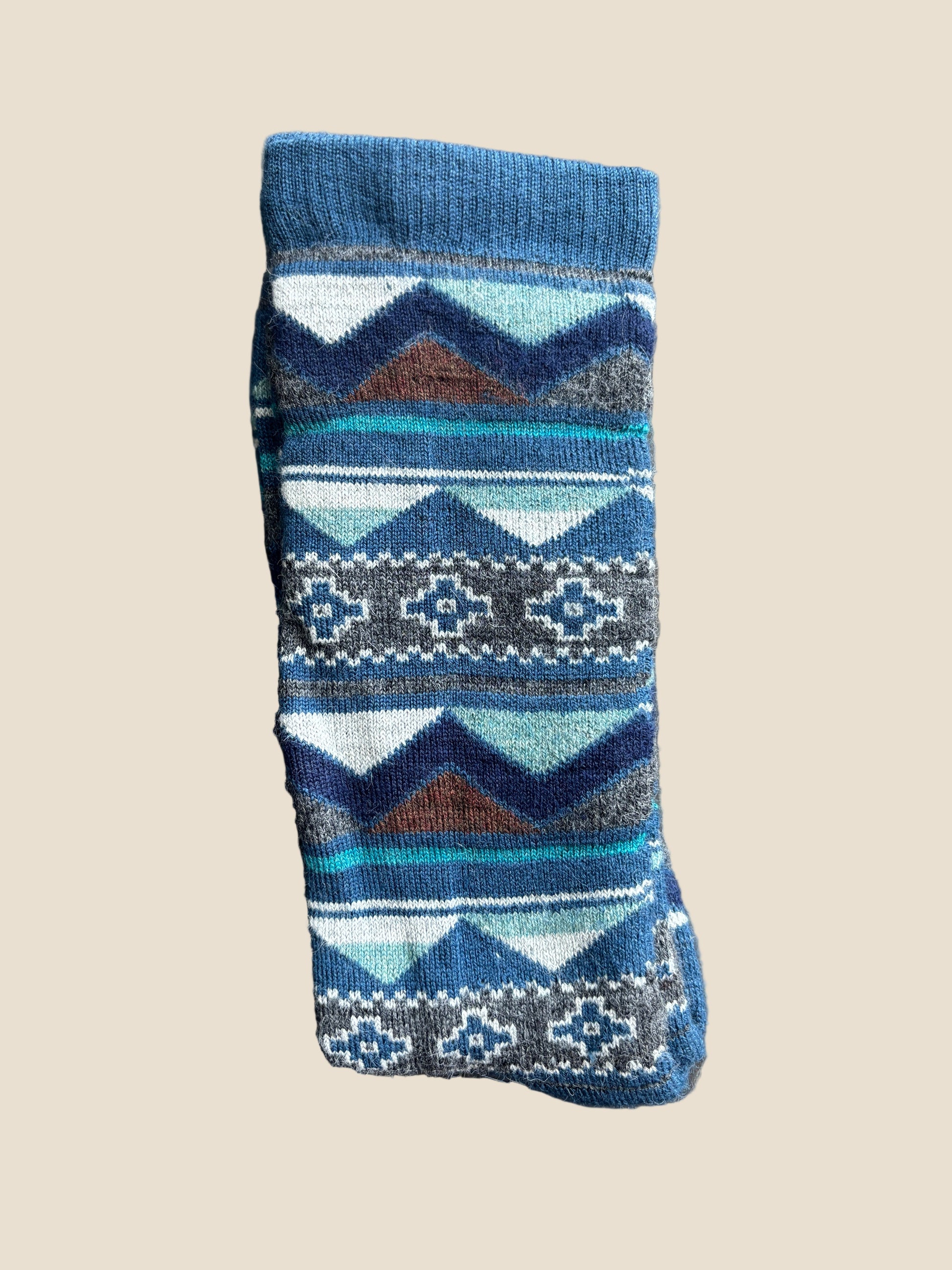 Blue patterned sock on a textured gray surface