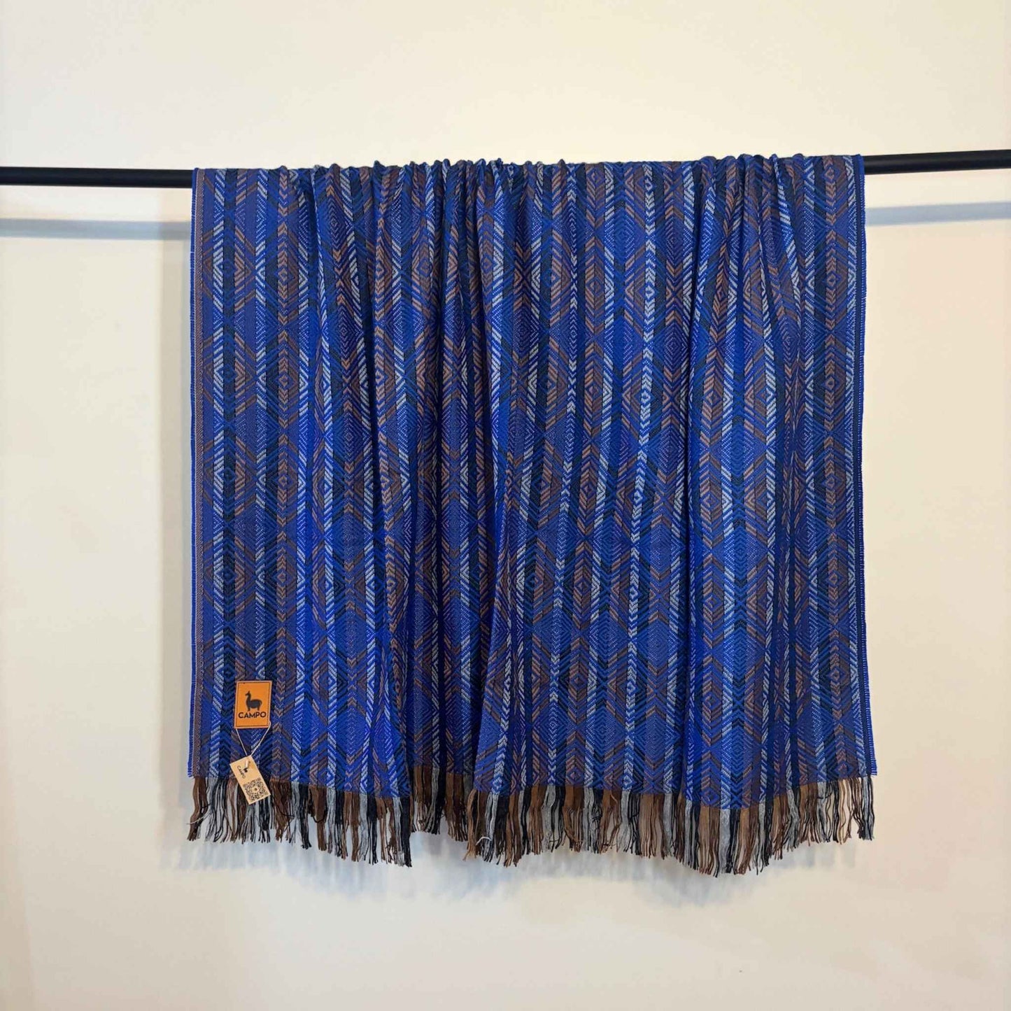 Blue patterned scarf with fringes on a white background