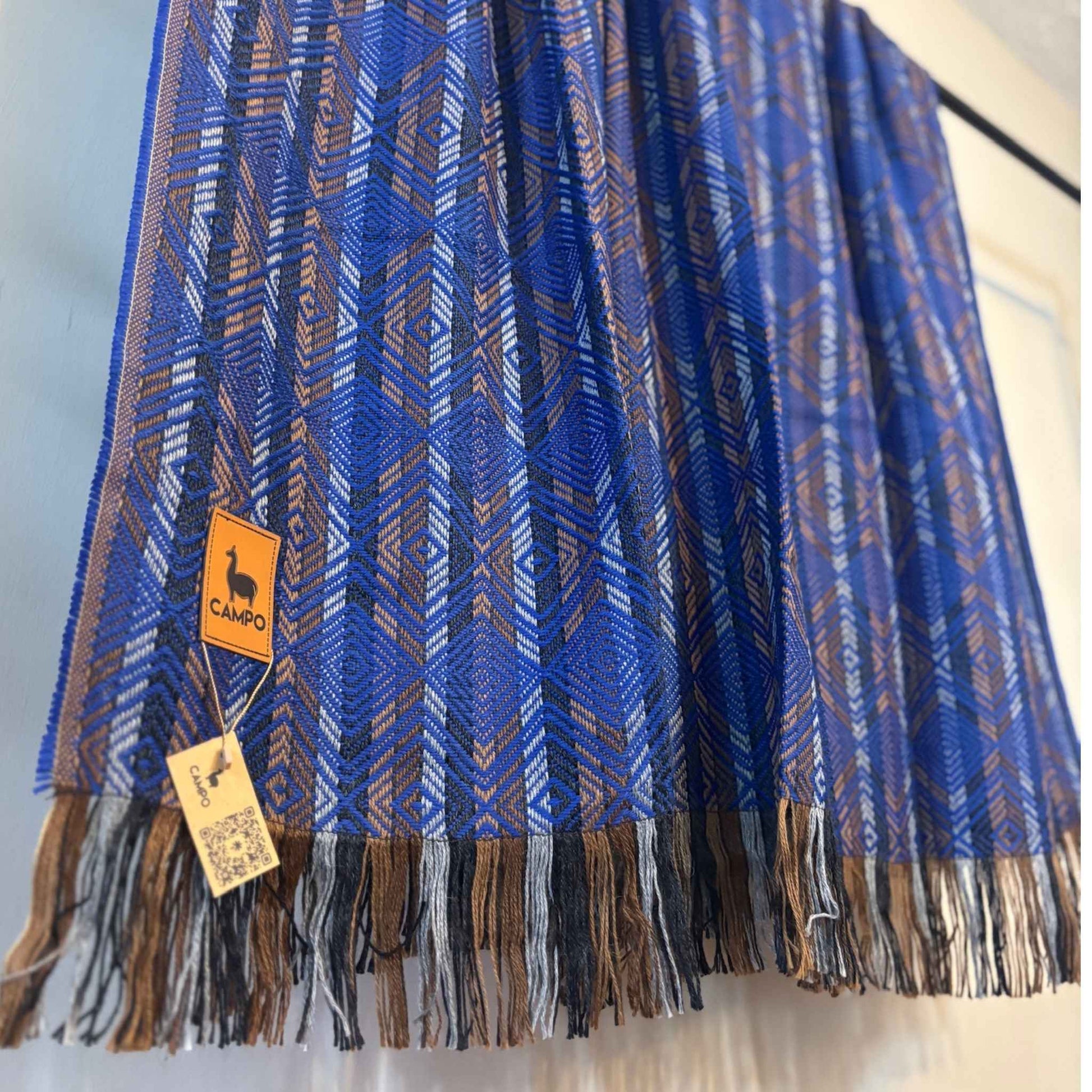 Blue and brown patterned scarf with a visible brand tag on a white background