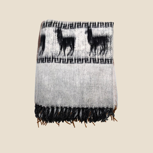 Woven blanket with black llama pattern on a beige background