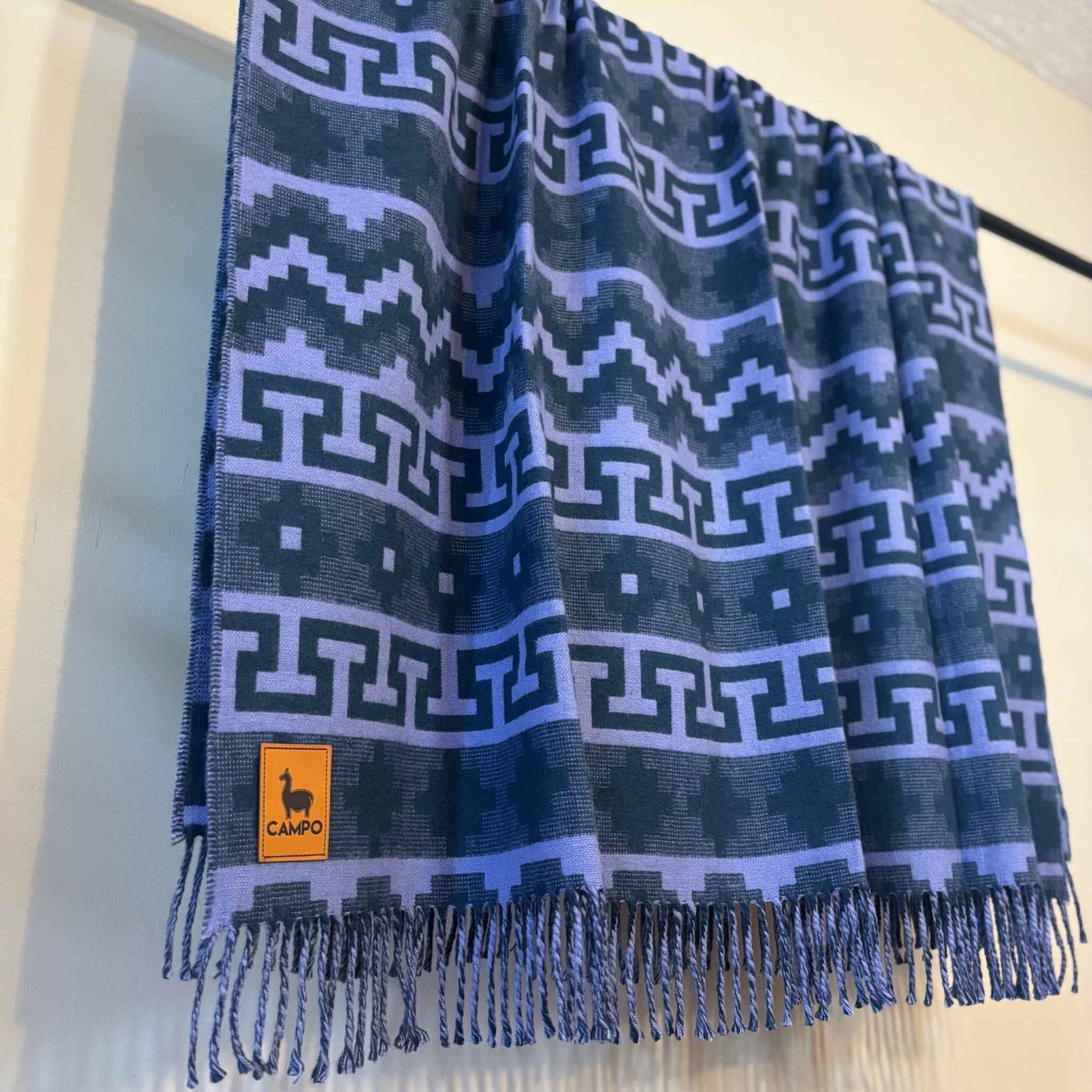 Sapphire blue patterned scarf with a brand logo on a white background