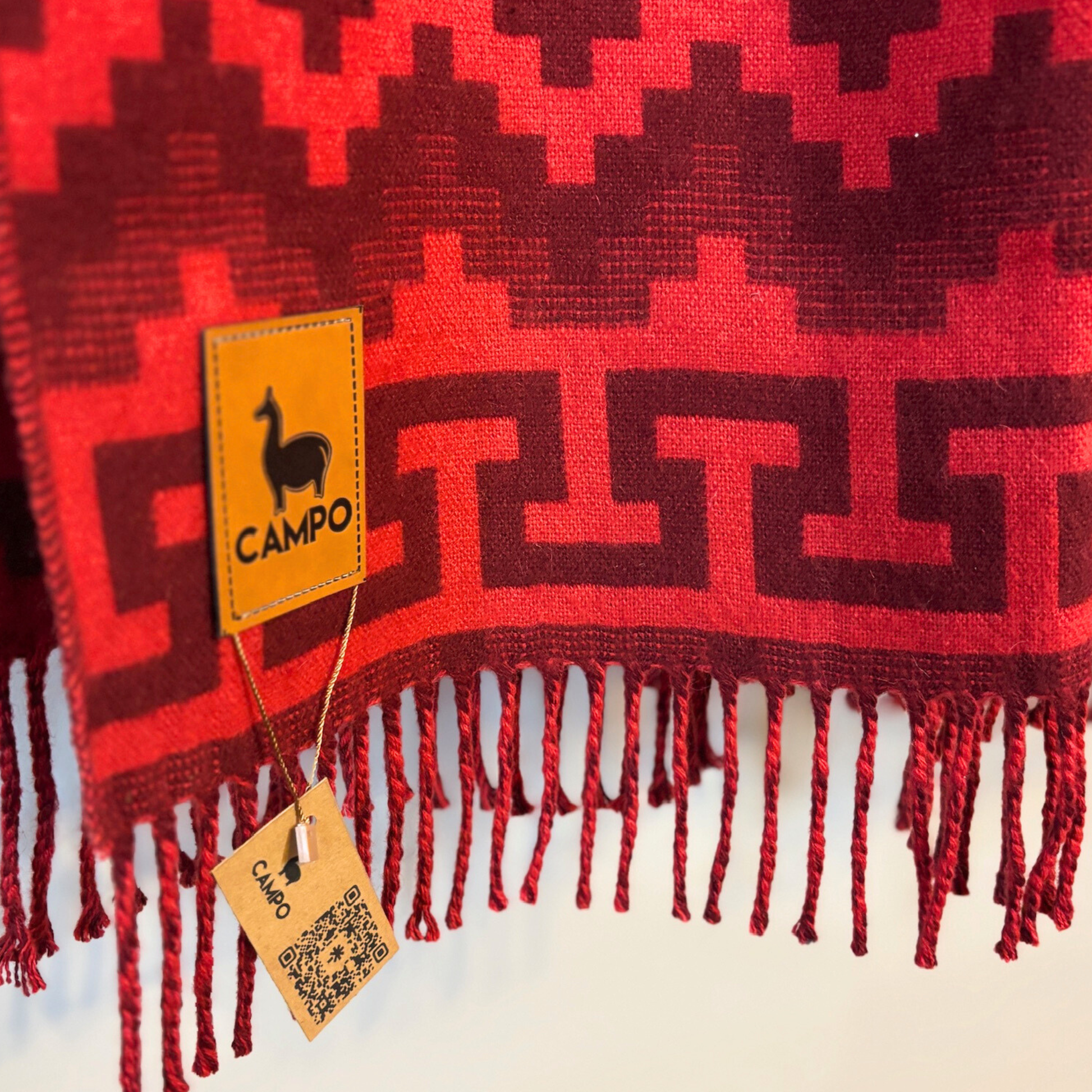 Red patterned fabric with fringes and a 'Campo' brand tag.