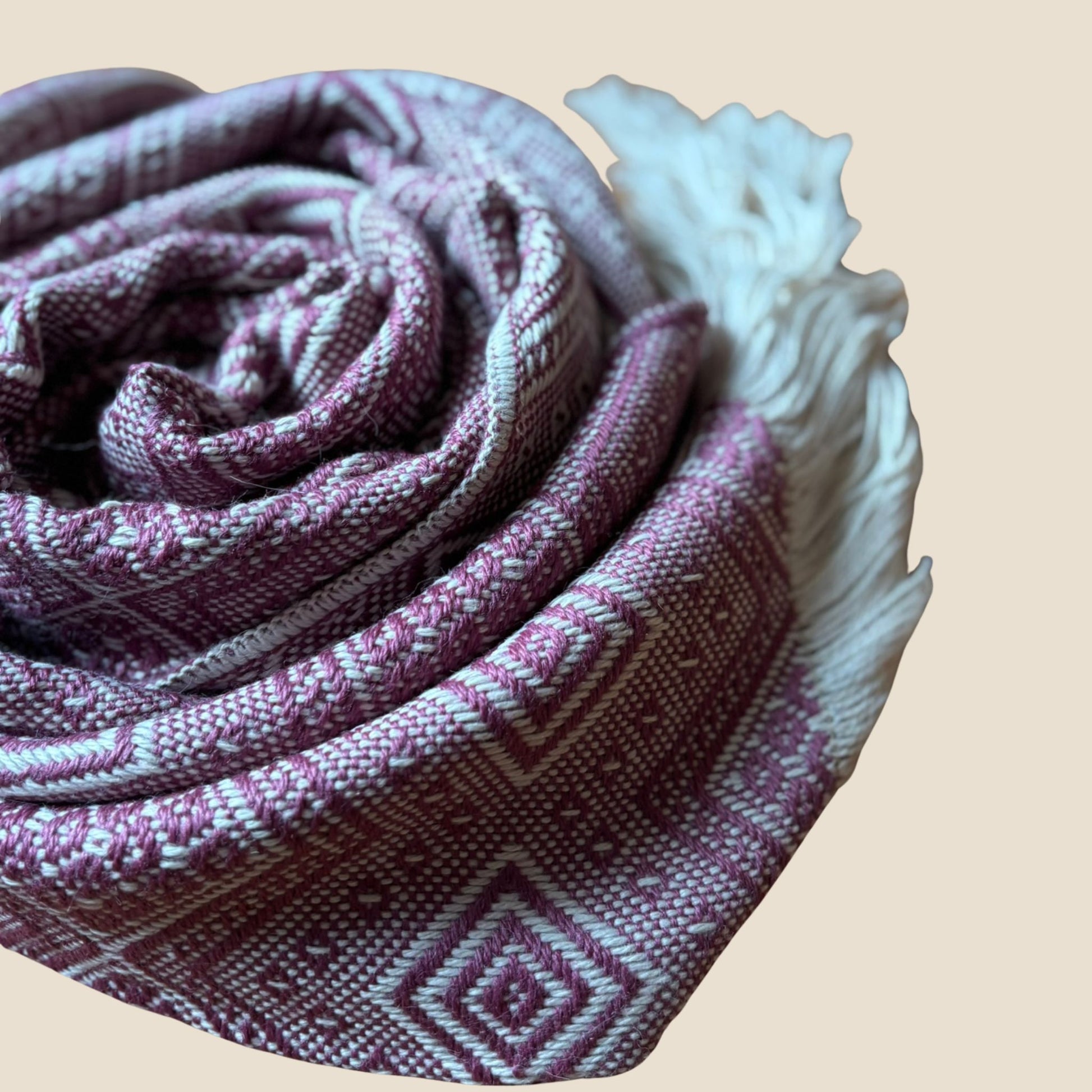 Folded fabric with a geometric pattern on a beige background