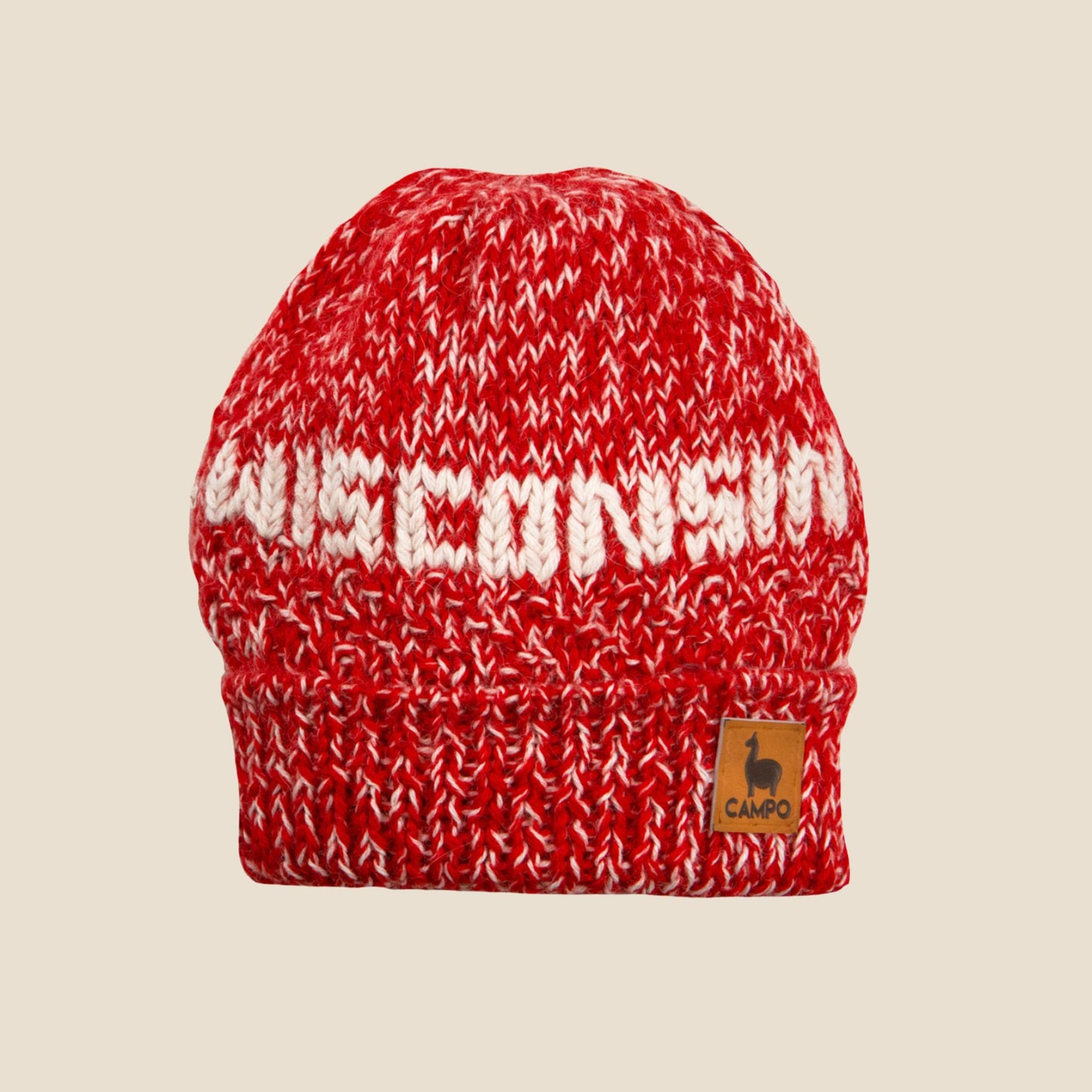 Red and white knitted beanie with 'Wisconsin' text on a beige background