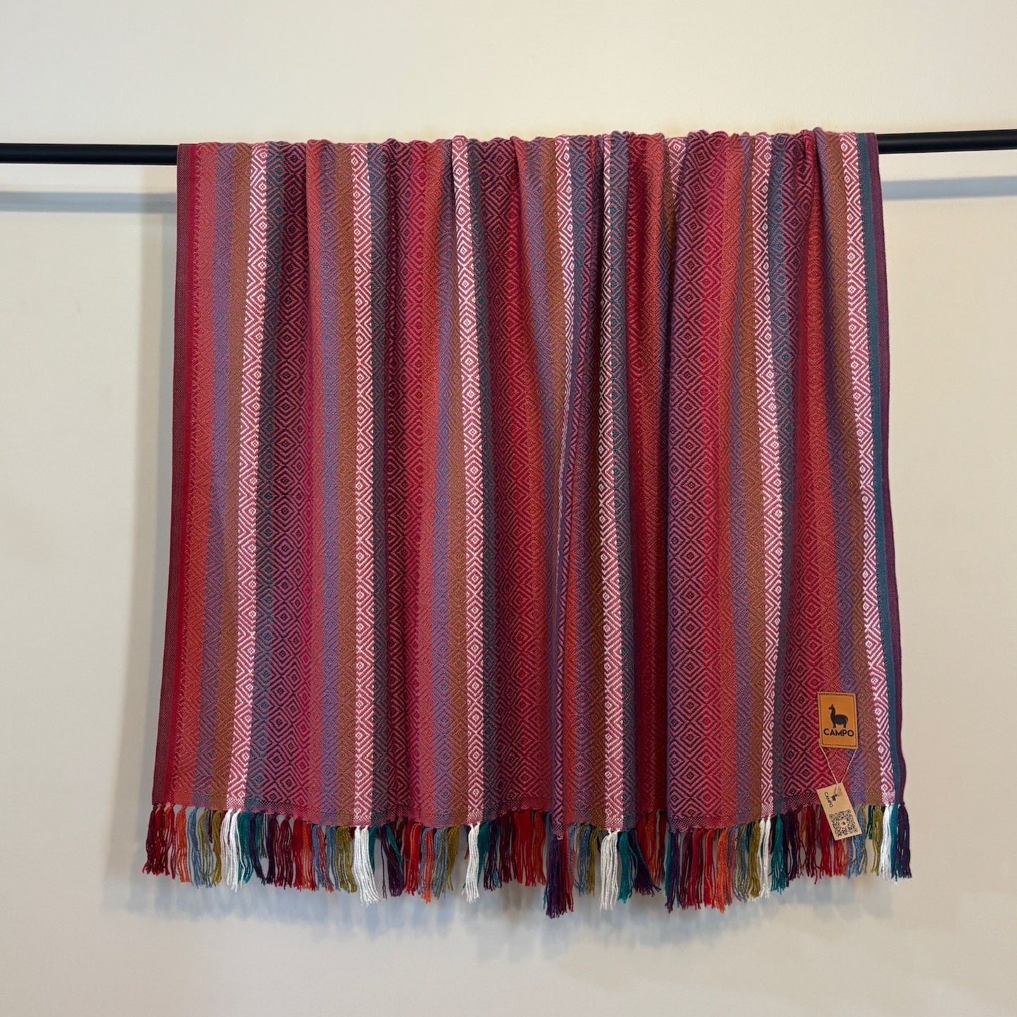 Pink Striped fabric with colorful fringes on a white background