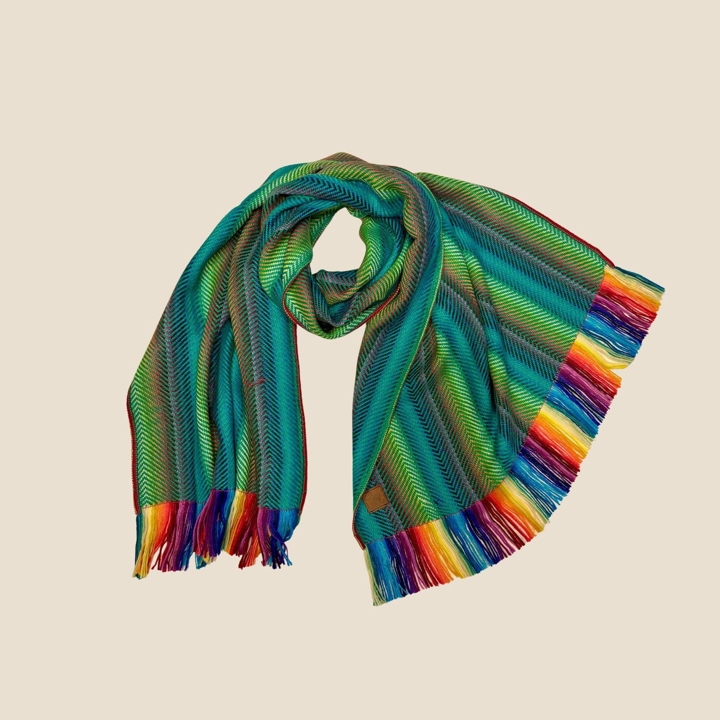 Colorful striped scarf with fringes on a beige background