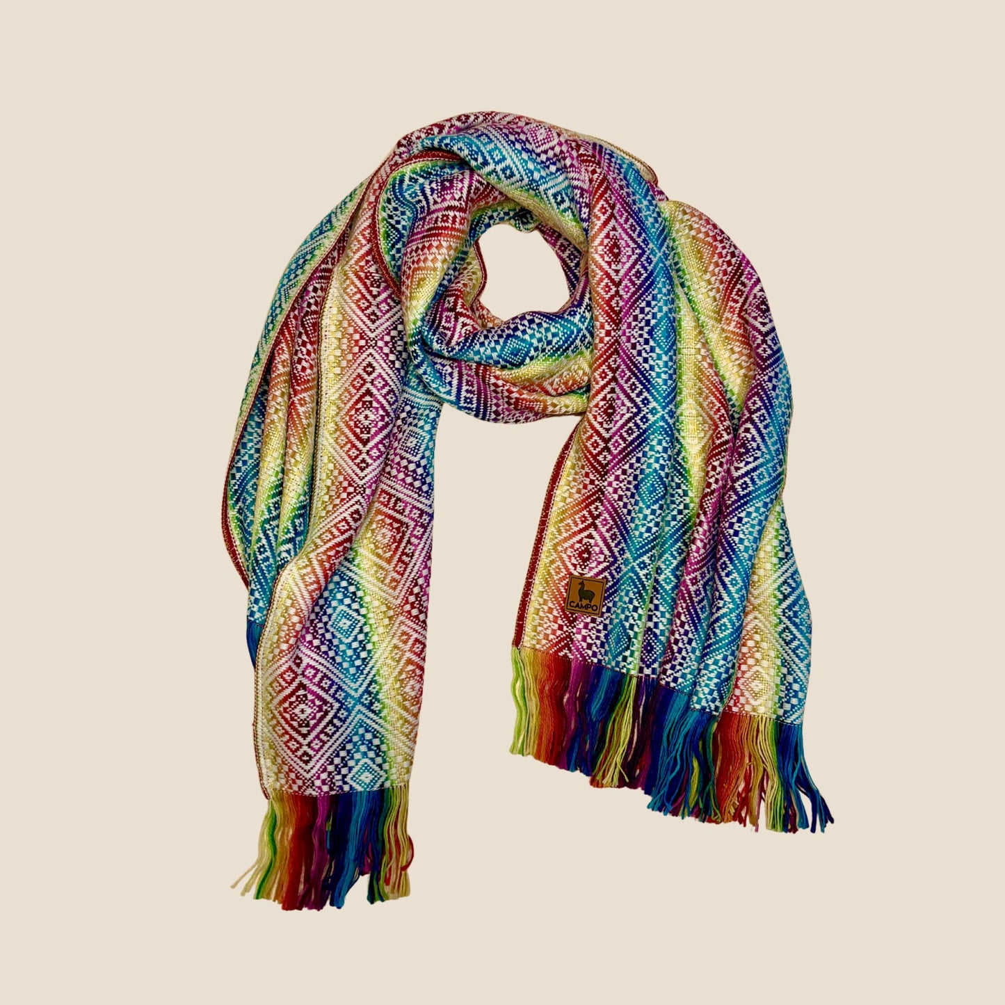 Colorful patterned scarf with fringes on a beige background