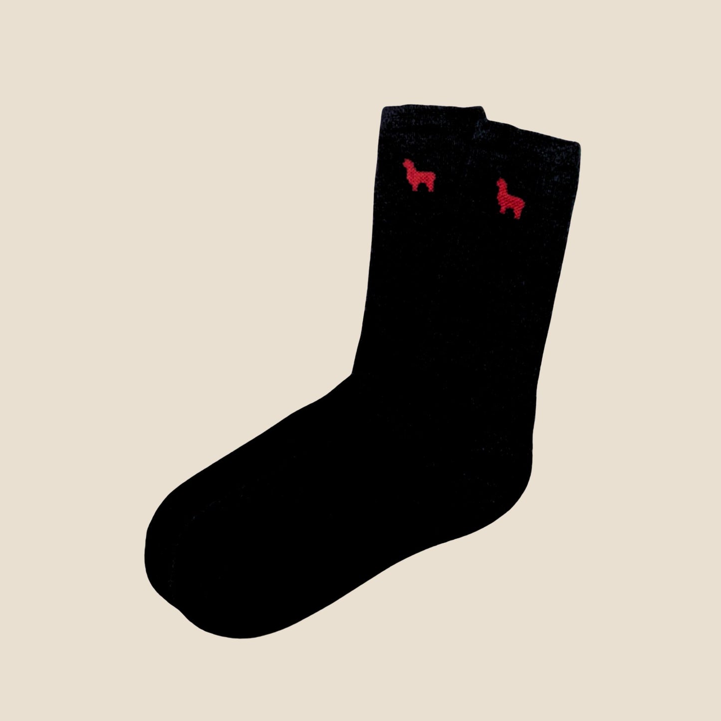 Black socks with red  alpaca designs on a beige background