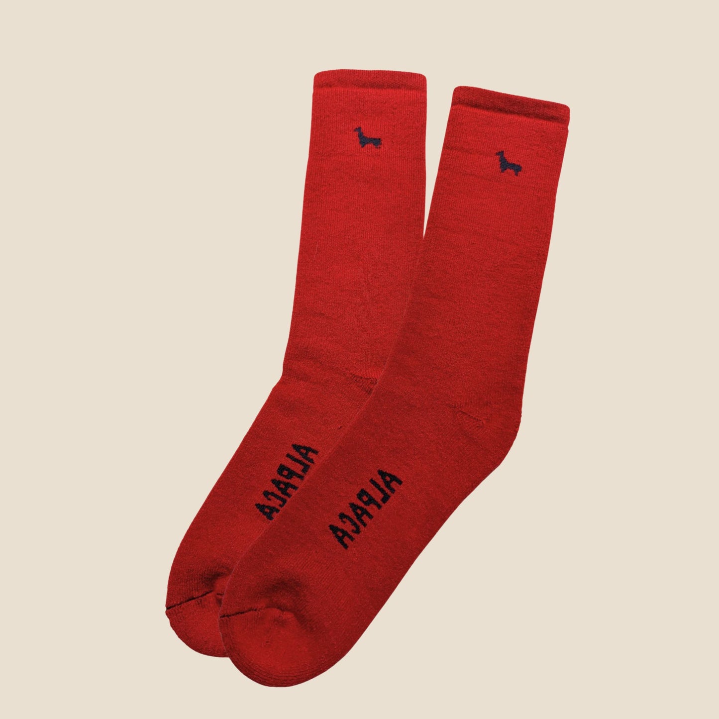 Red socks with black text and logo on a beige background