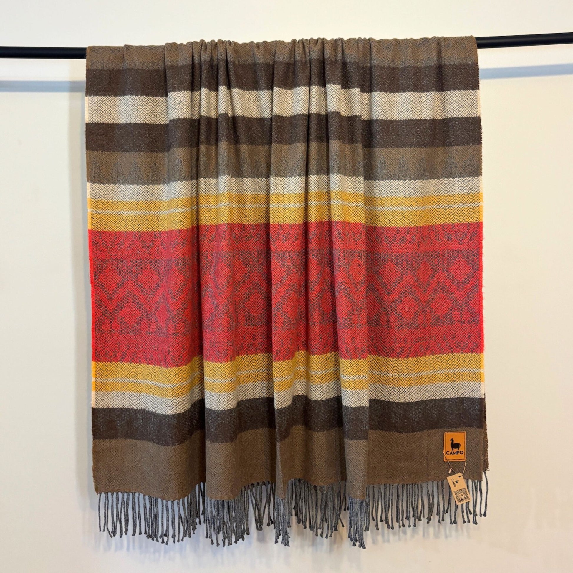 Red medley striped scarf with red, yellow, and brown colors on a white background