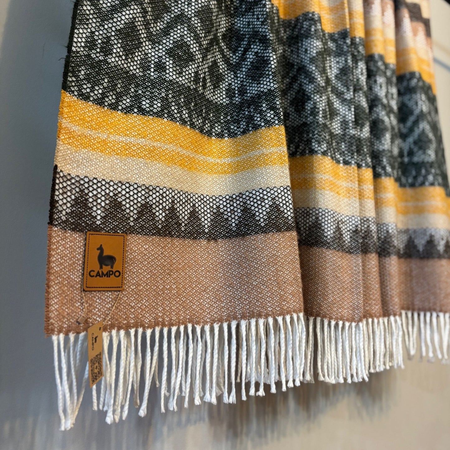 Green medley textured blanket with a 'Campo' brand tag on a neutral background