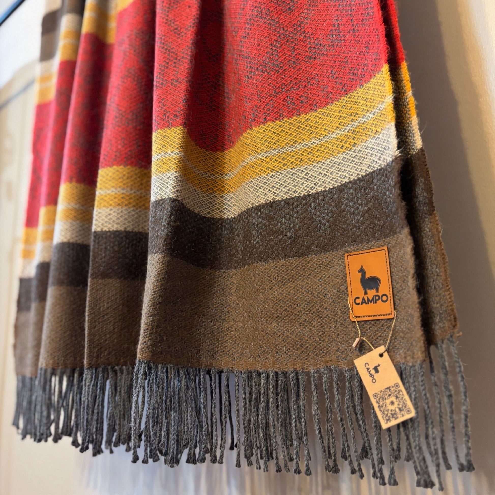Red medley striped scarf with a 'Campo' brand tag on a neutral background