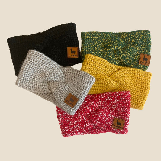 Five twisted headband in black, green, gray, yellow, and red on a beige background.