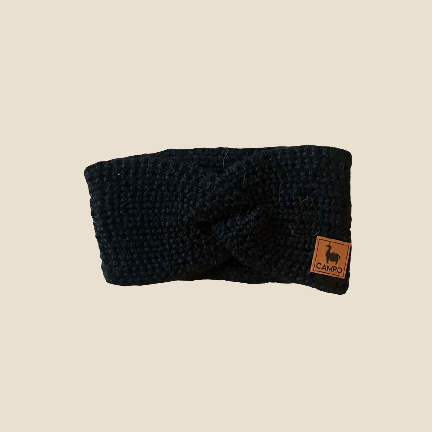 Black twisted headband with a 'Campo' label on a beige background