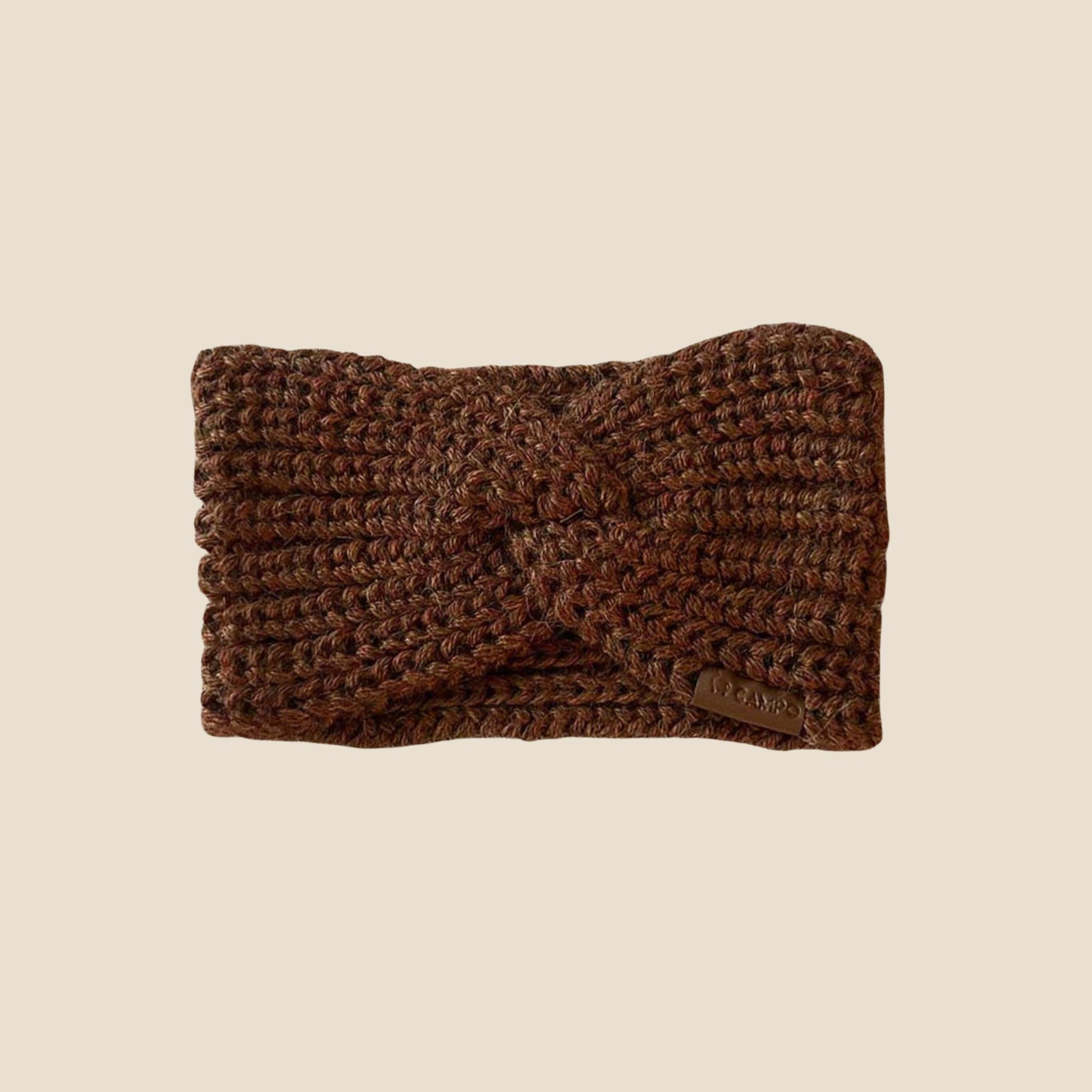 Brown knitted headband on a beige background