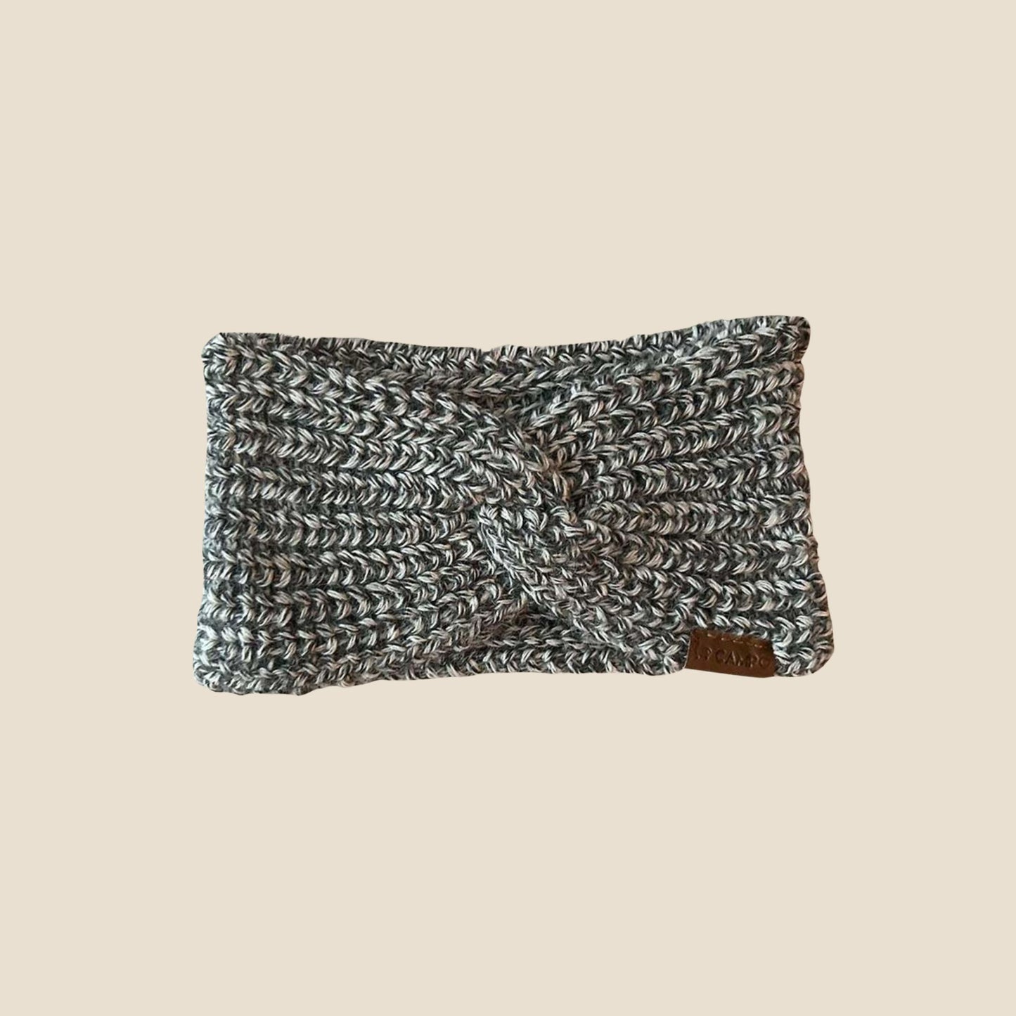 Twisted headband with a textured pattern on a beige background