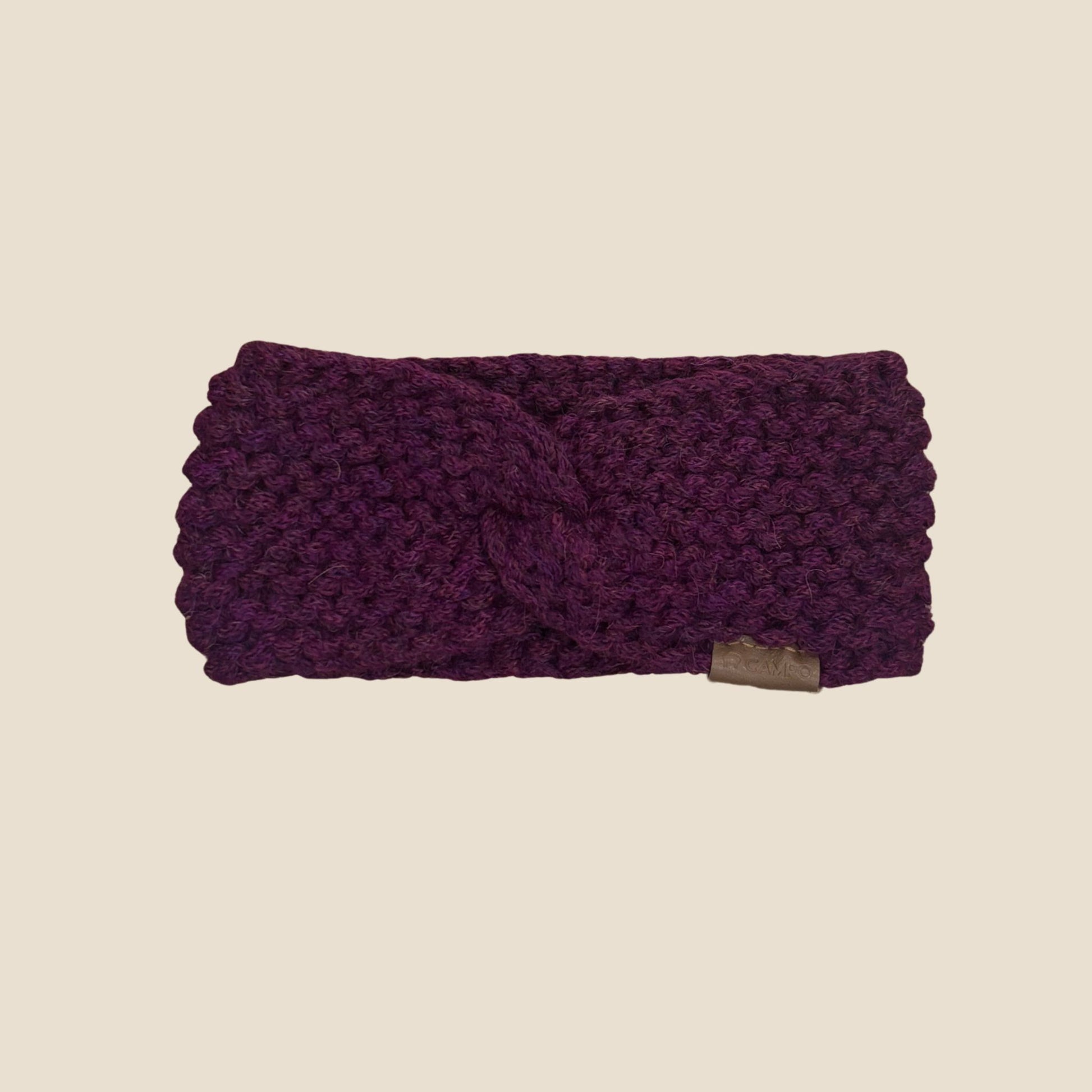 Purple Twisted headband on a beige background