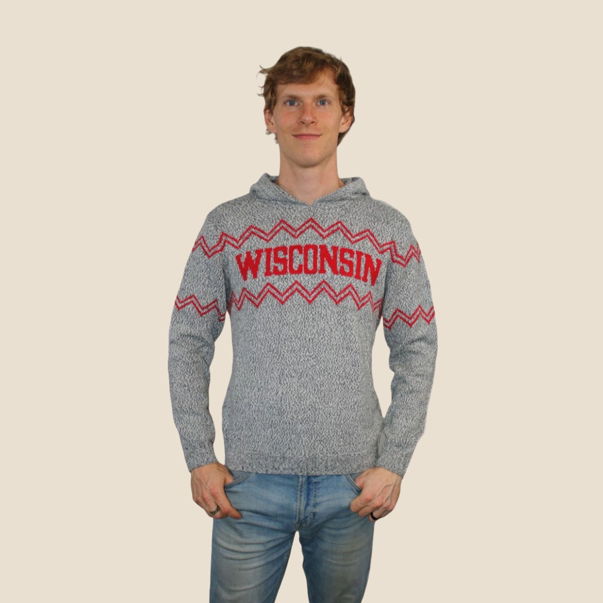 Person wearing a gray hoodie with 'Wisconsin' printed on it against a beige background