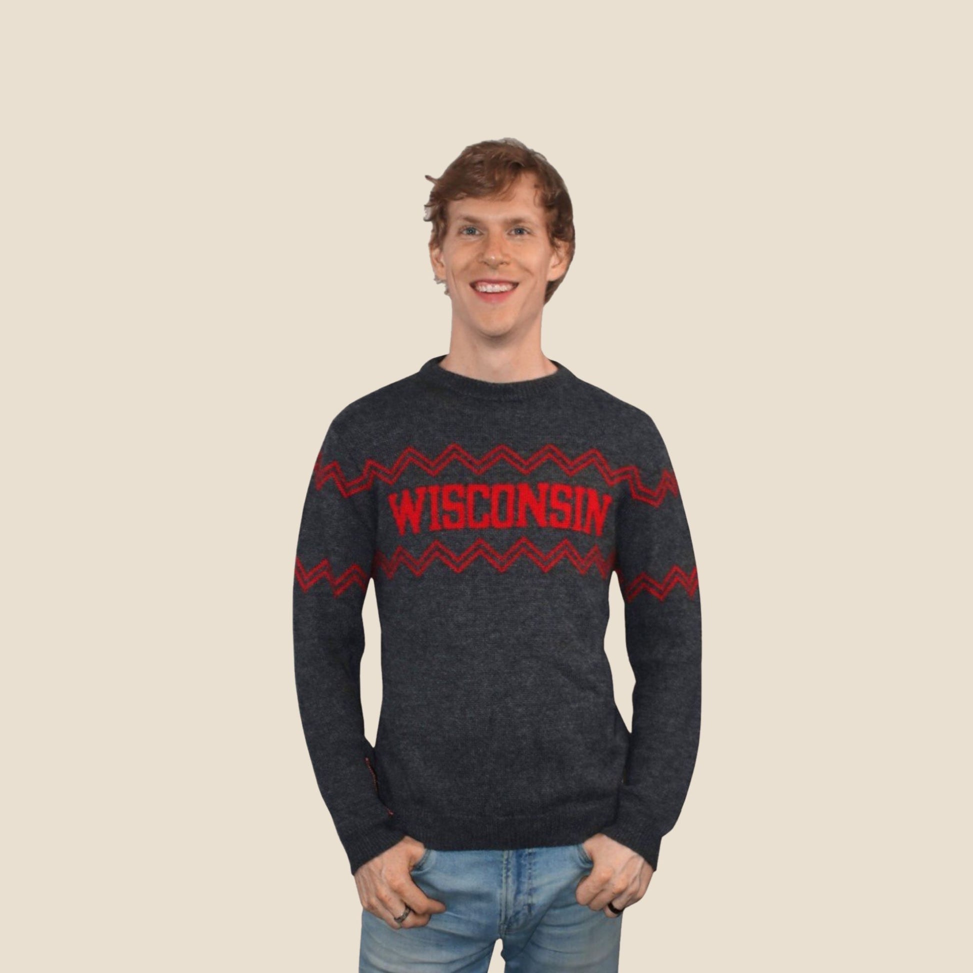 Person wearing a dark gray sweater with 'Wisconsin' printed in red on a beige background