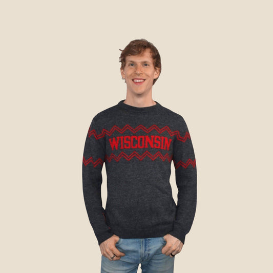 Person wearing a dark gray sweater with 'Wisconsin' printed in red on a beige background