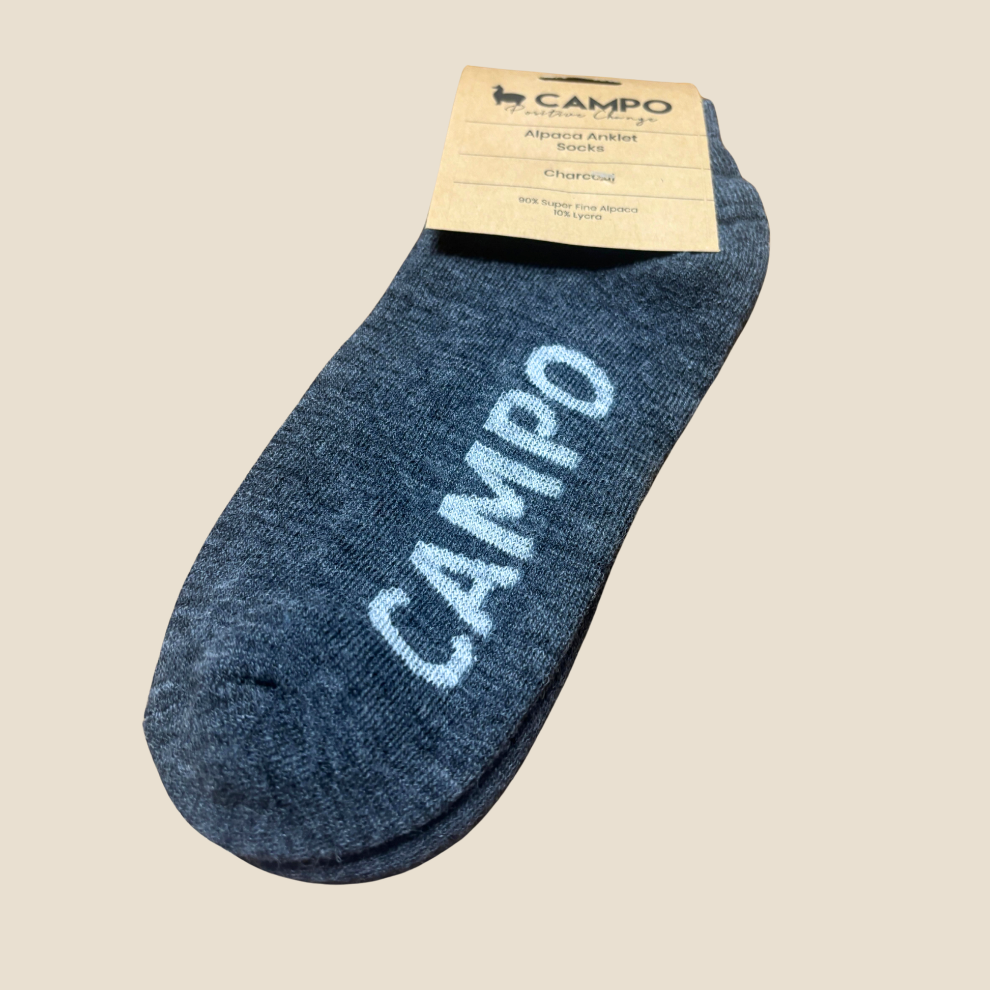 Charcoal ankle sock with 'CAMPO' branding on a beige background
