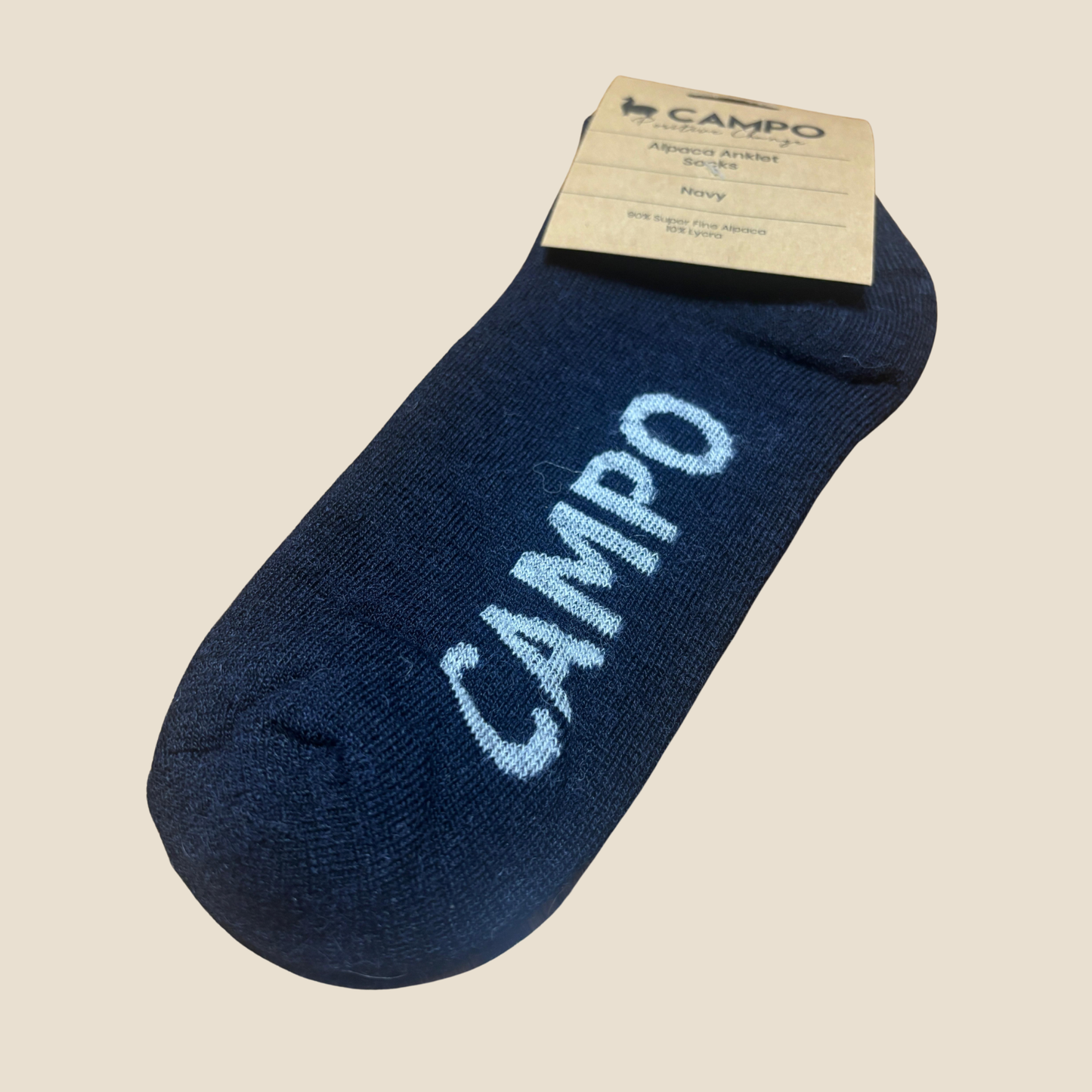 Blue ankle sock with 'Campo' branding on a beige background