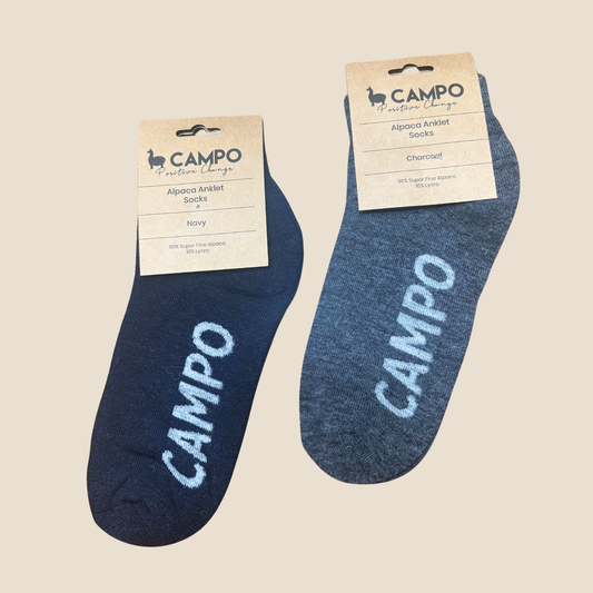Two pairs of blue ankle socks with 'Campo' branding on a beige background