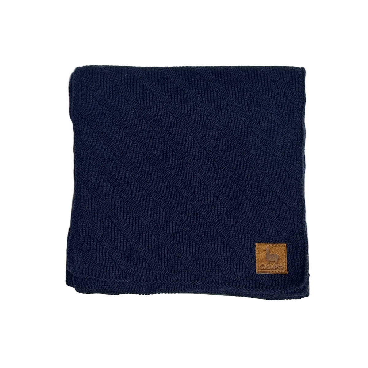 A folded navy blue ribbed knit scarf or neck warmer with a small tan leather patch on the lower right corner, displayed on a light textured surface.