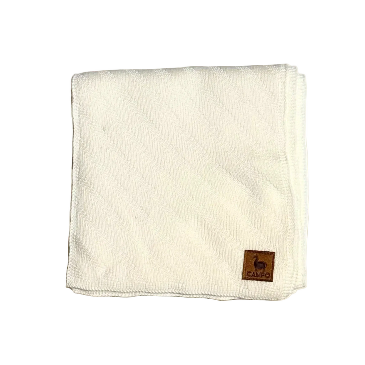 An off-white textured microfiber cloth folded into a square, featuring a small brown leather brand patch on the bottom right corner with the brand name 'Cares' and a deer logo.