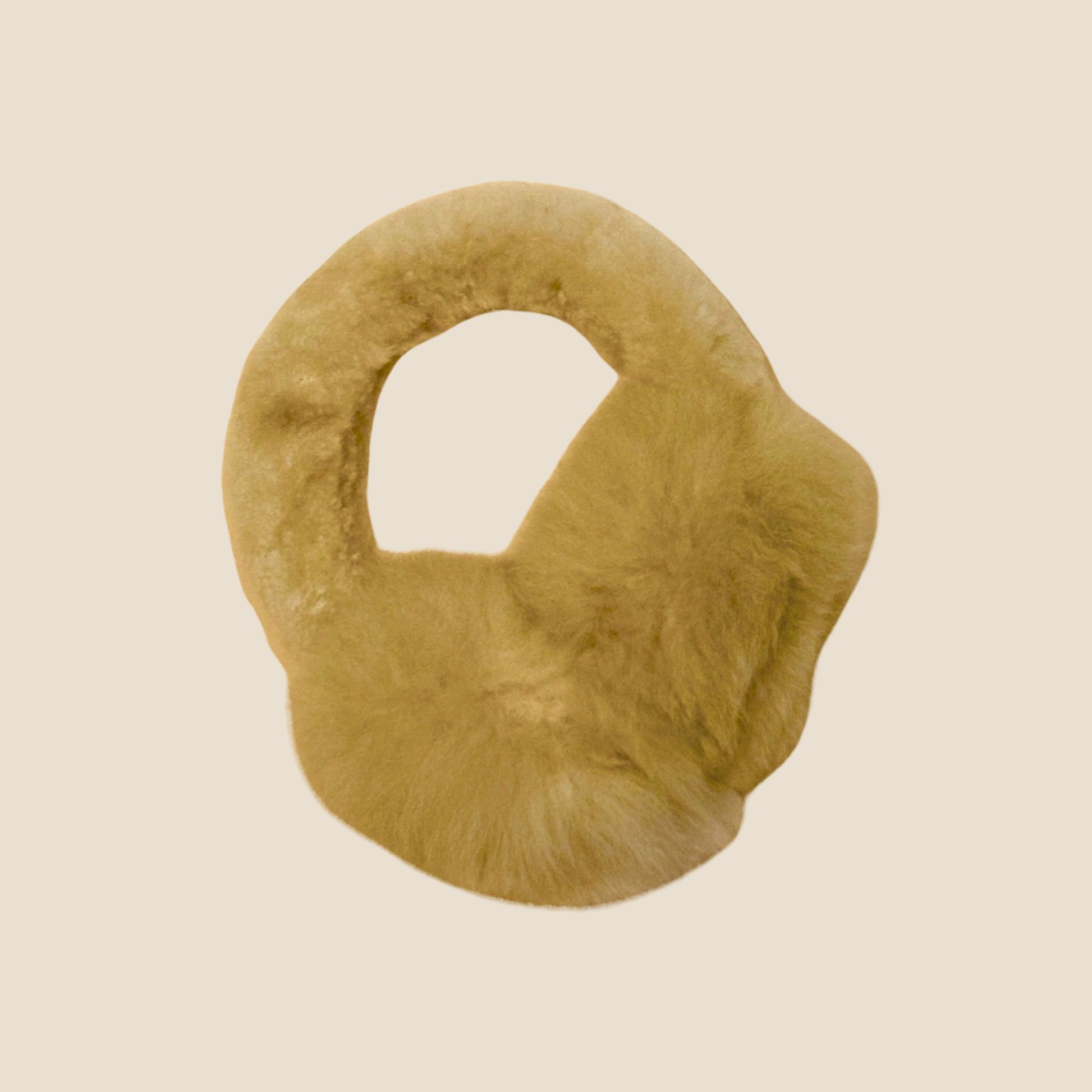 Tan ear muffs on a beige background