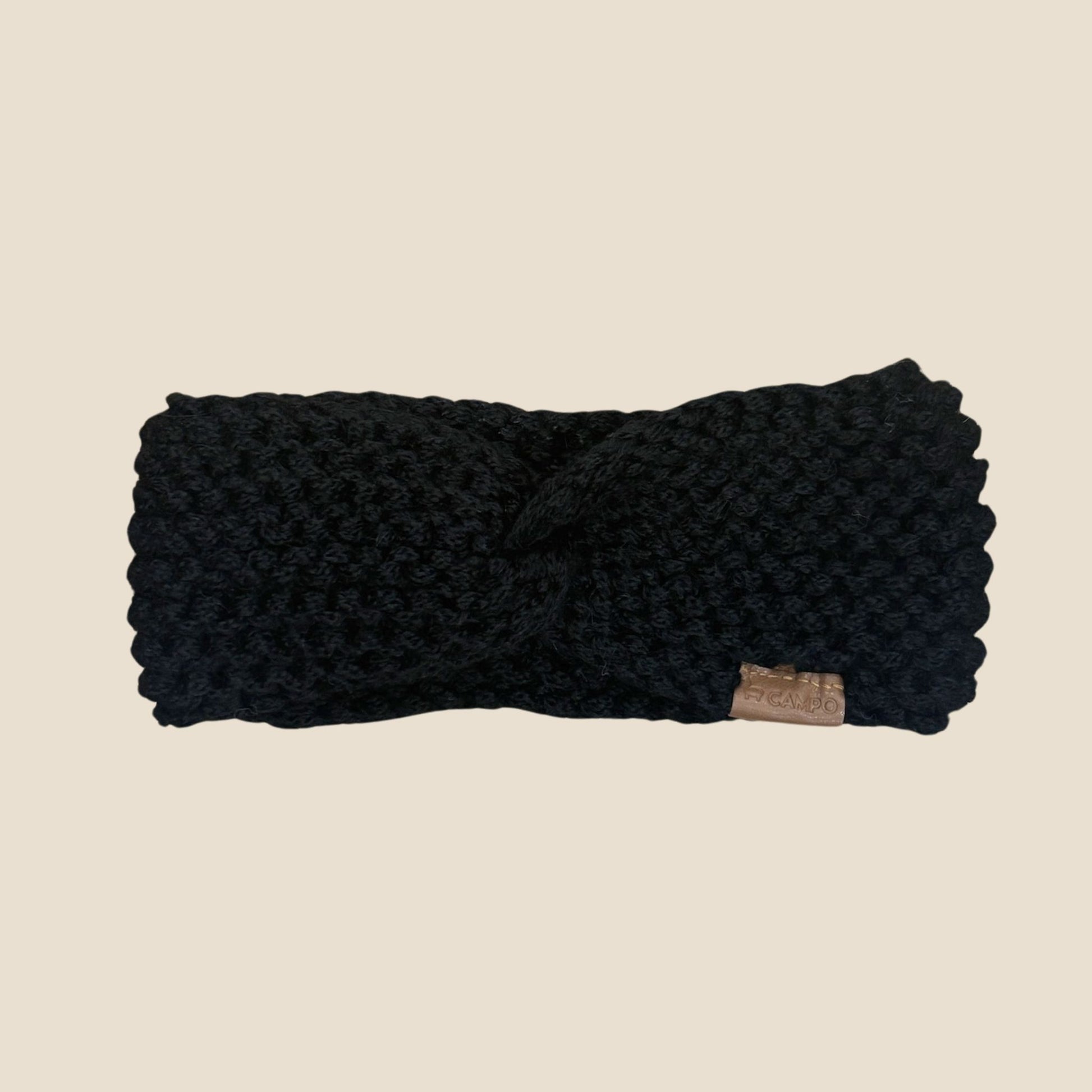 Black Twisted headband on a beige background