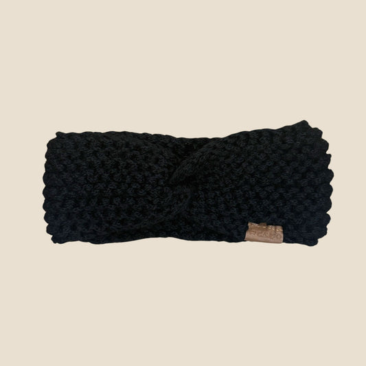 Black Twisted headband on a beige background