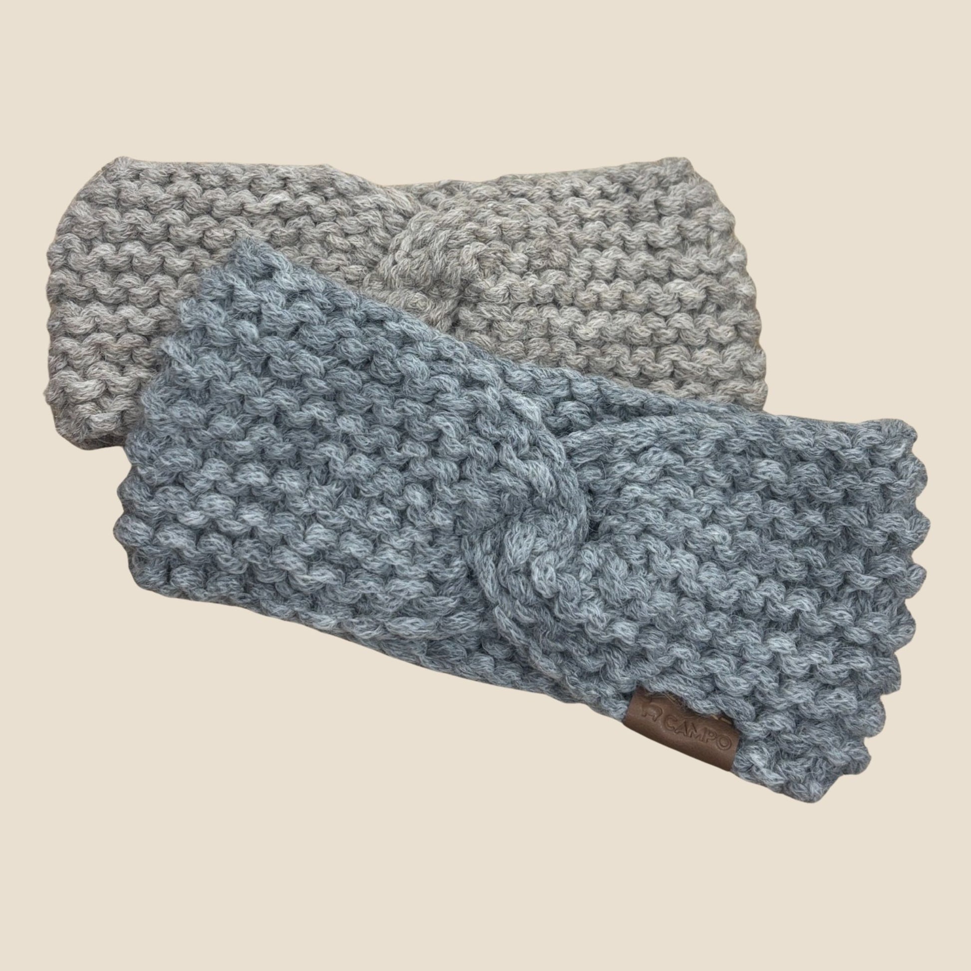 Two twisted headbands on a beige background.