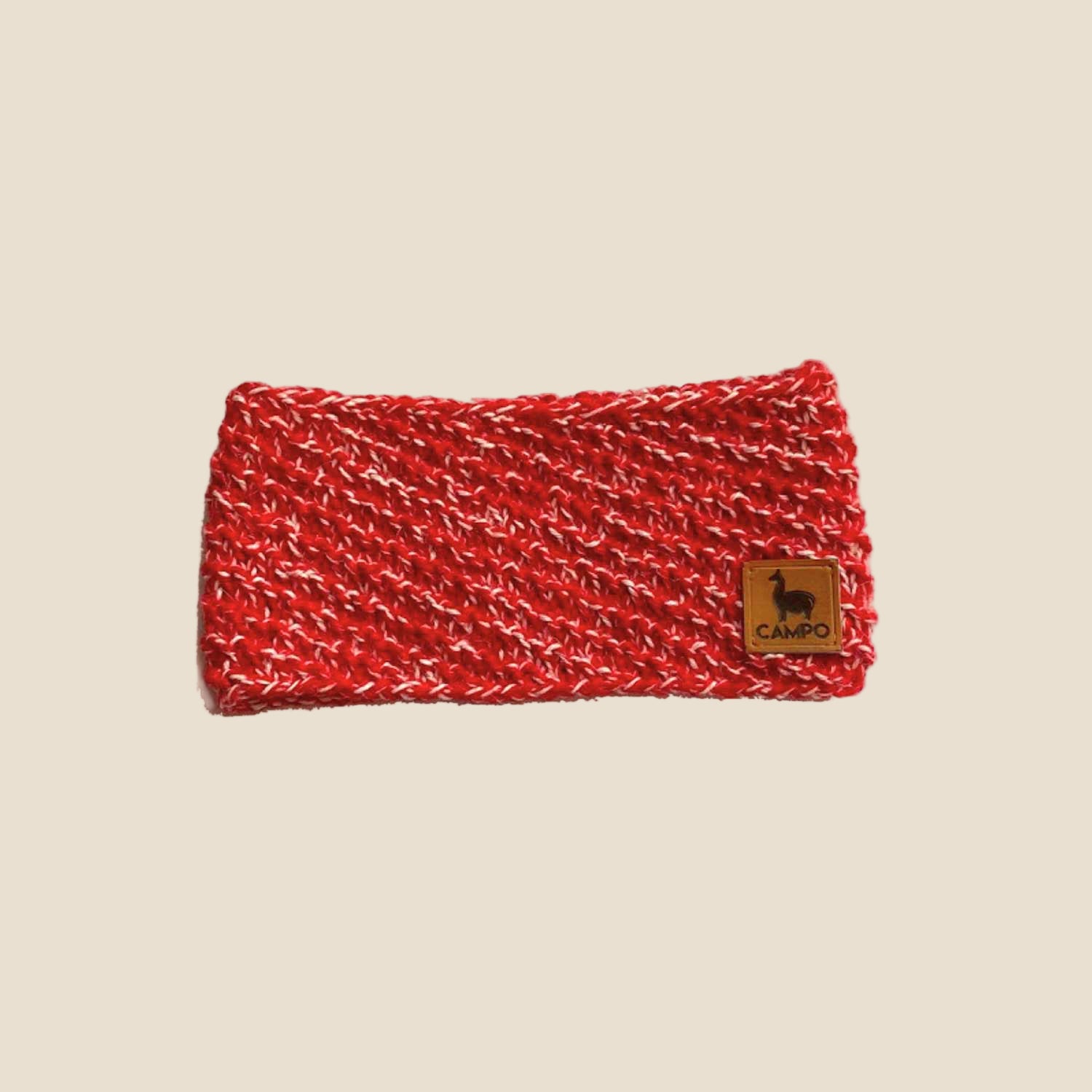 Red knitted headband with a brand logo on a white background