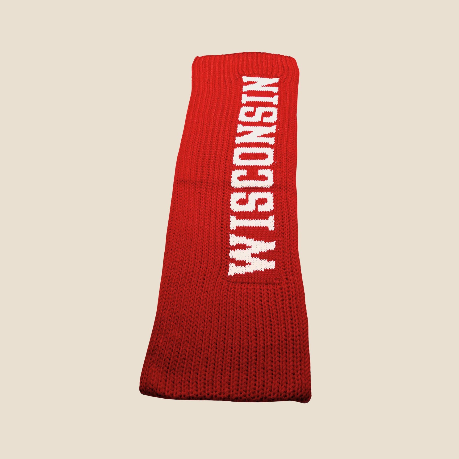 Red knitted dog sweater with 'WISCONSIN' text on a beige background