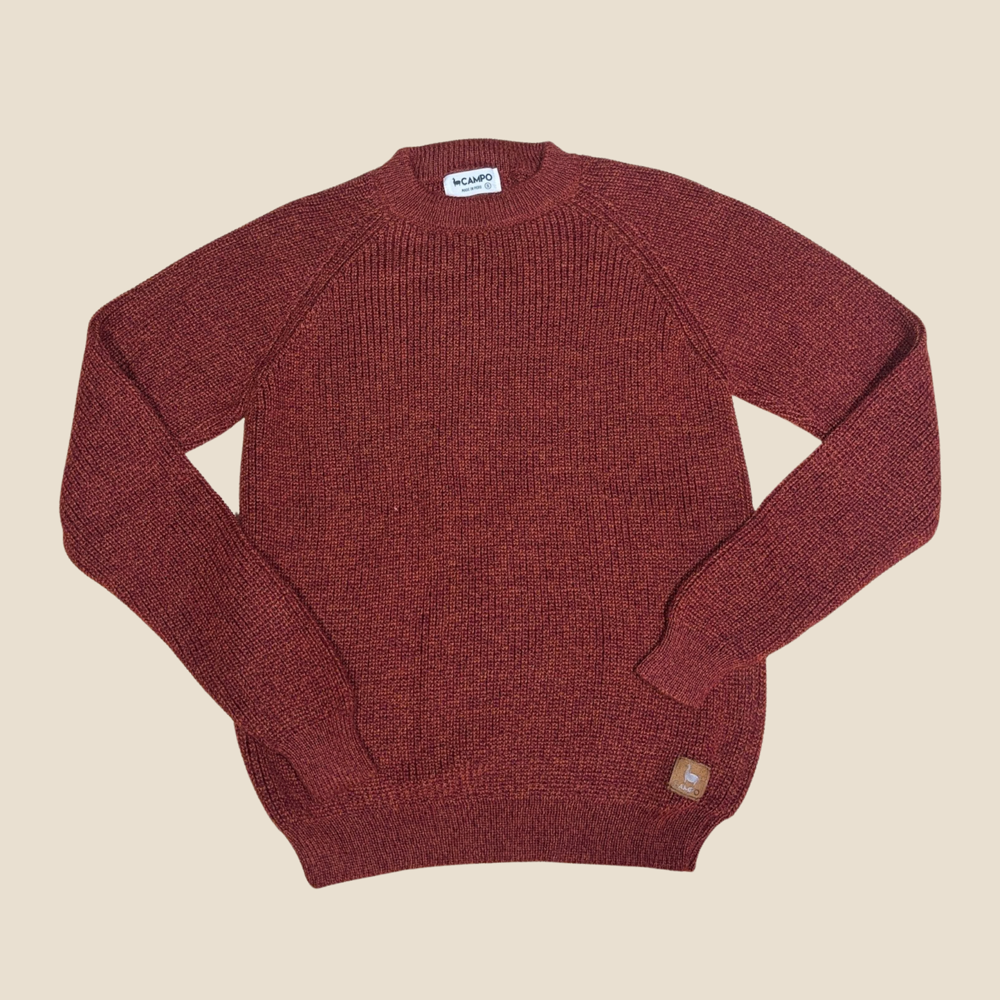 Maroon sweater on a beige background