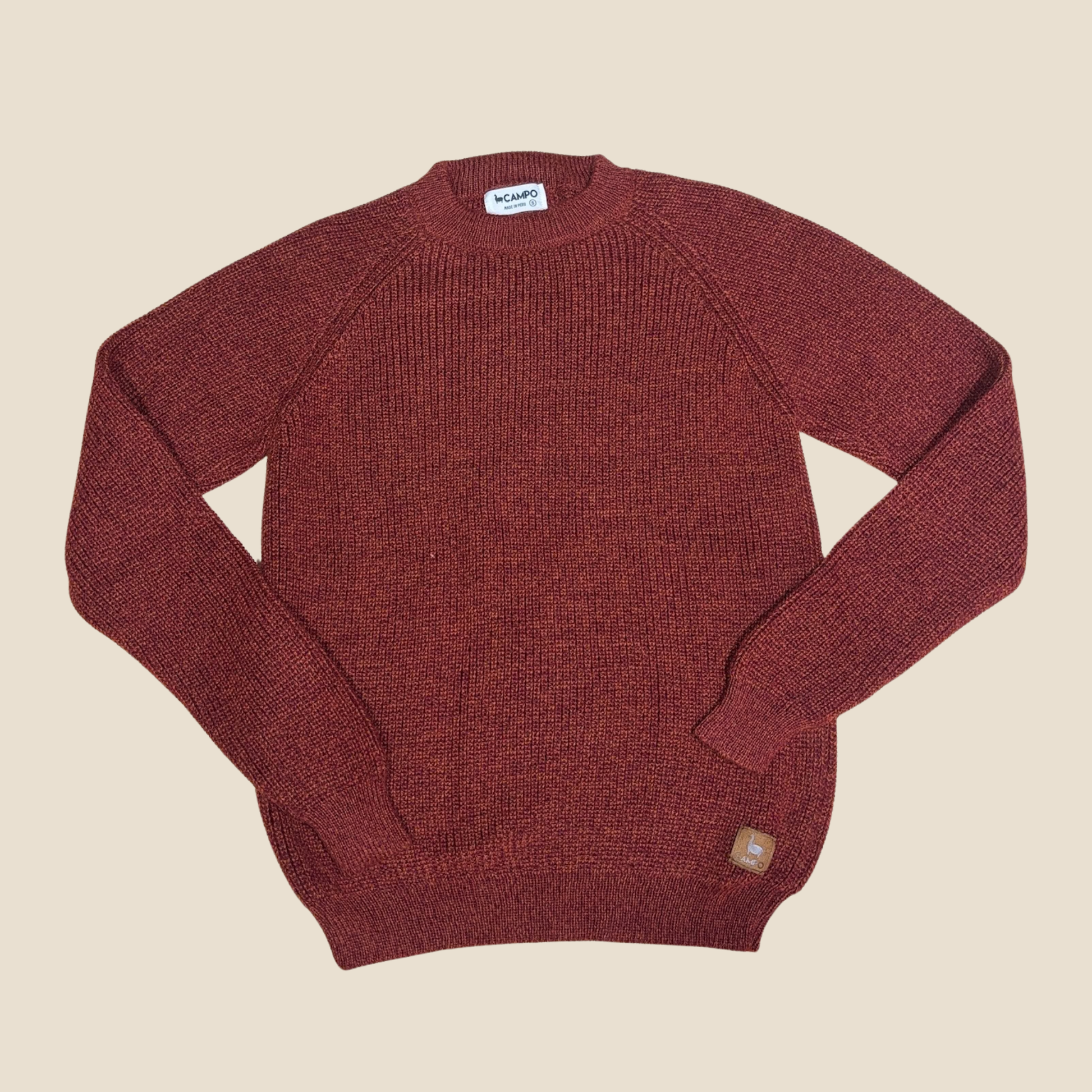 Maroon sweater on a beige background