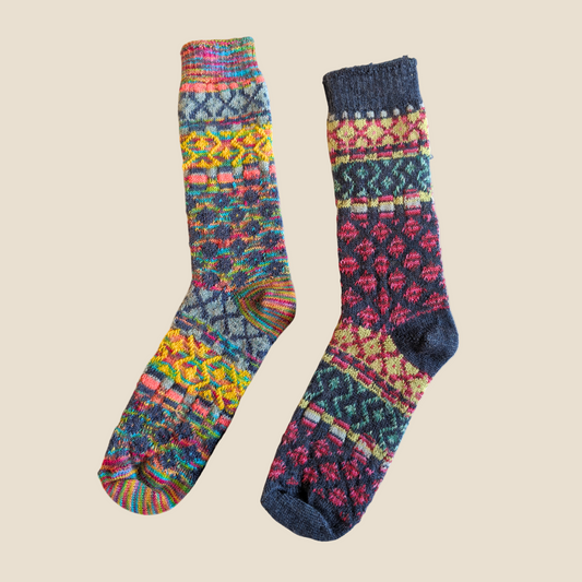 Pair of colorful patterned socks on a white background
