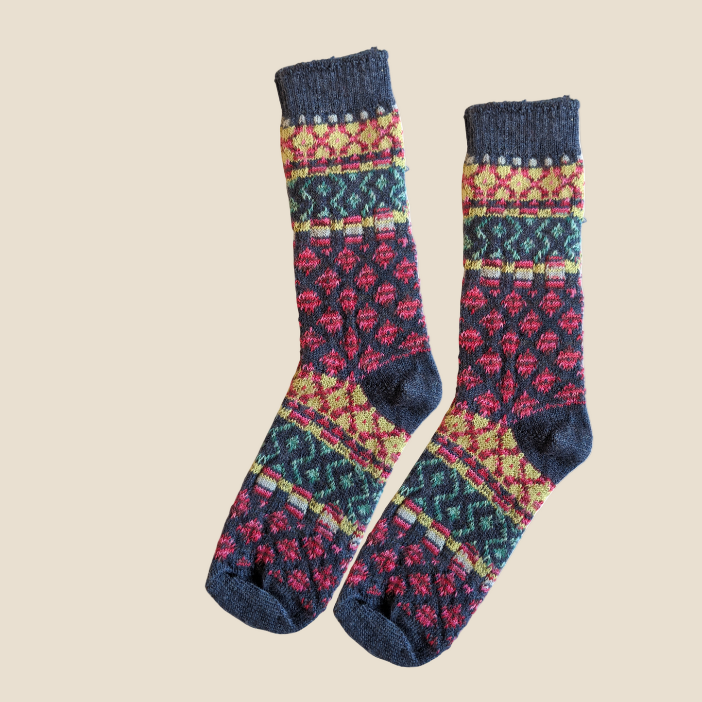 Colorful patterned socks with denim cuffs on a white background