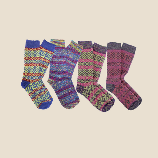 A set of colorful alpaca fiber socks with geometric patterns, displayed in four different designs.