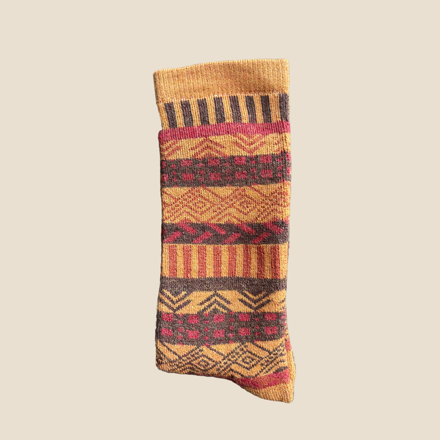 Wool sock with geometric pattern on a beige background