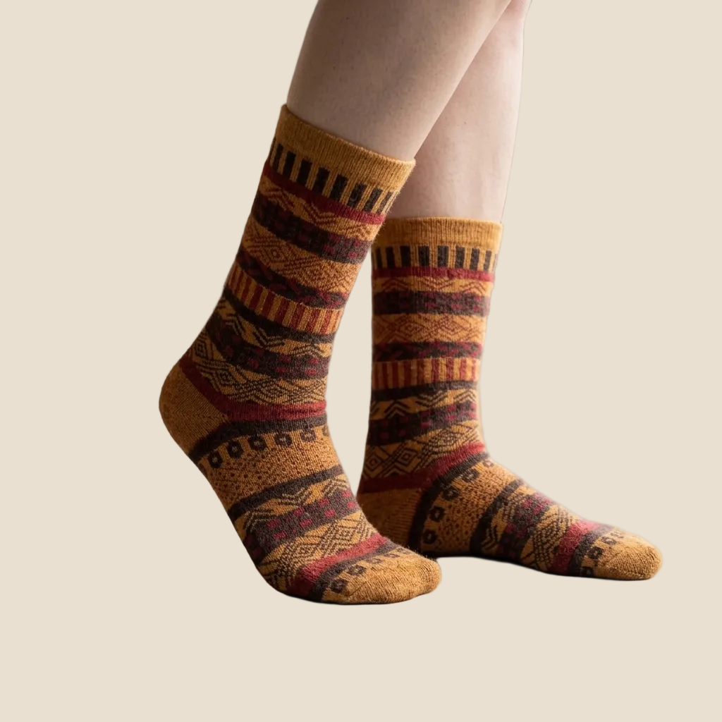 Patterned socks worn on a beige background