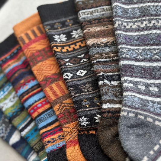 Collection of patterned socks in various colors on a white background