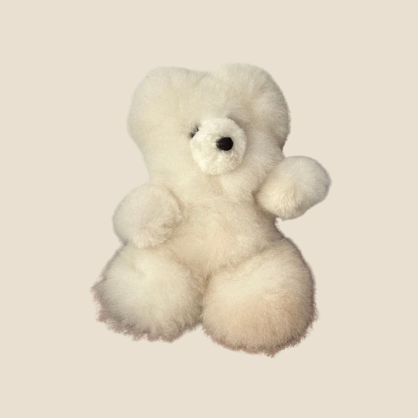 White teddy bear on a beige background