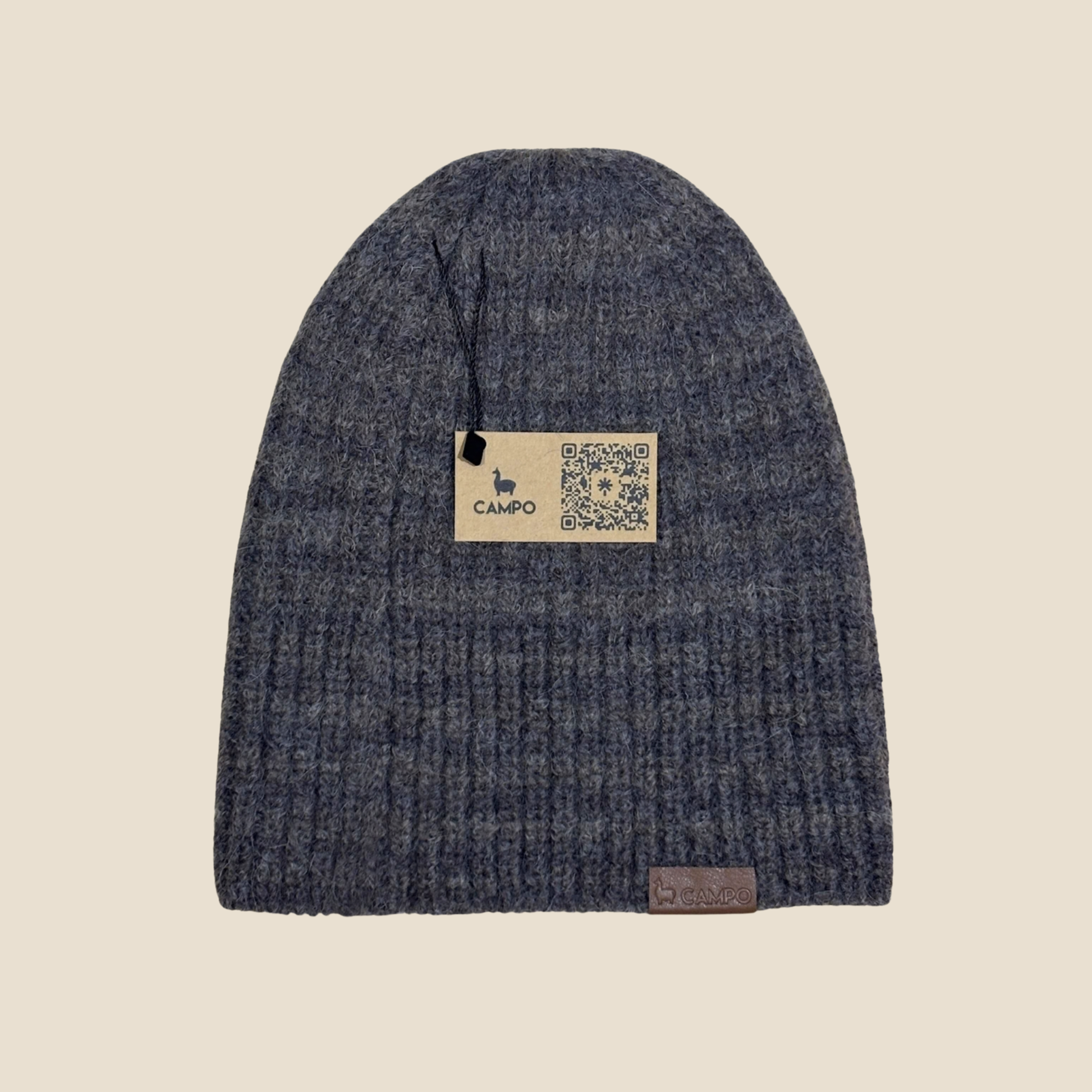 Blue knit beanie with a 'Campo' label on a beige background
