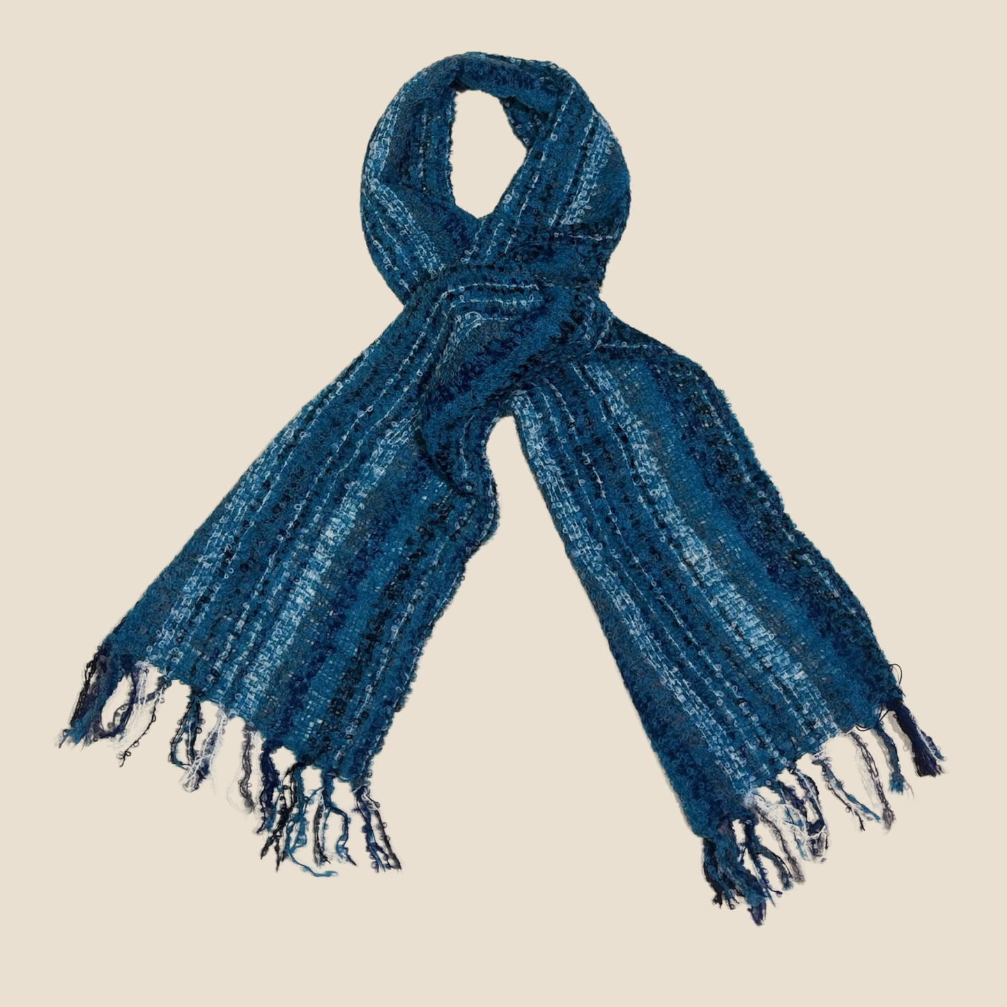 Blue scarf with fringes on a beige background