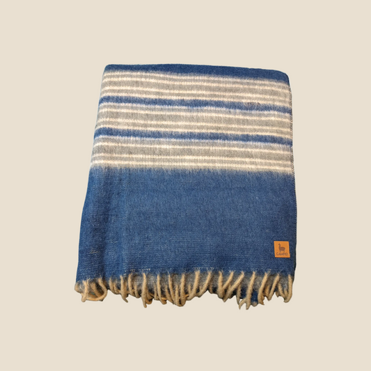 Striped blanket with blue and beige colors on a white background