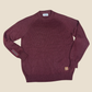 Merlot sweater with brand labels on a beige background