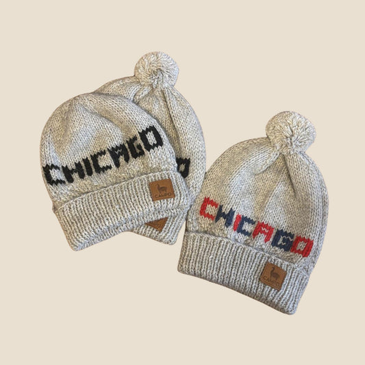 Two knit hats with 'Chicago' text on a beige background