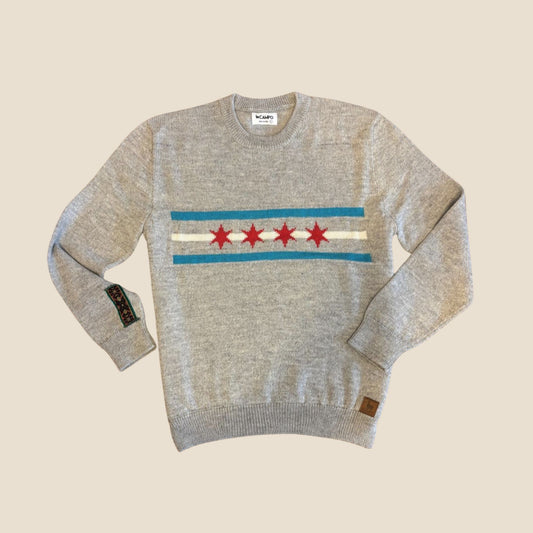 Gray sweater with red stars and blue stripes on a beige background